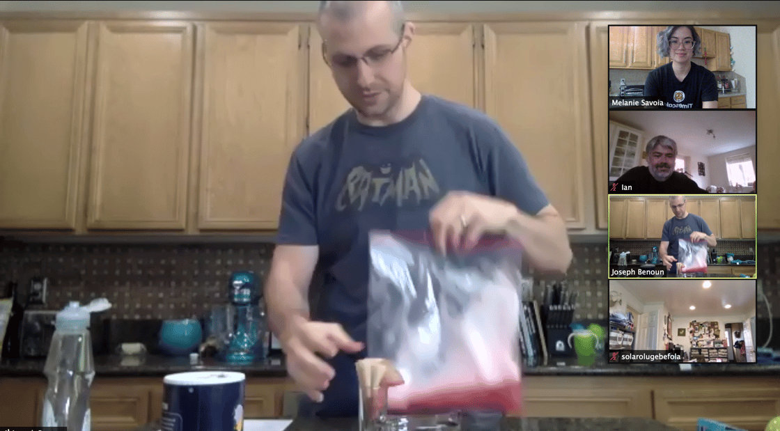 Man holding Ziploc bag in a kitchen, with 3 other video participants in Zoom video UI.
